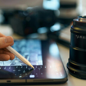 News organization content ingest automation: Digital workflow with tablet and stylus for global performance.