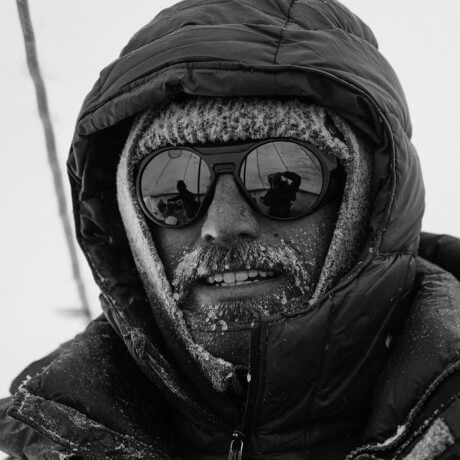 Nick Cahill on Pikes Peak. MASV Multiconnect enabled fast file transfer to L.A. studio. Black and white portrait.