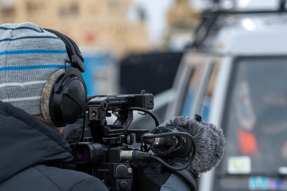 NRK: Cameraman with broadcast equipment. Norwegian Broadcasting Corporation customer story.